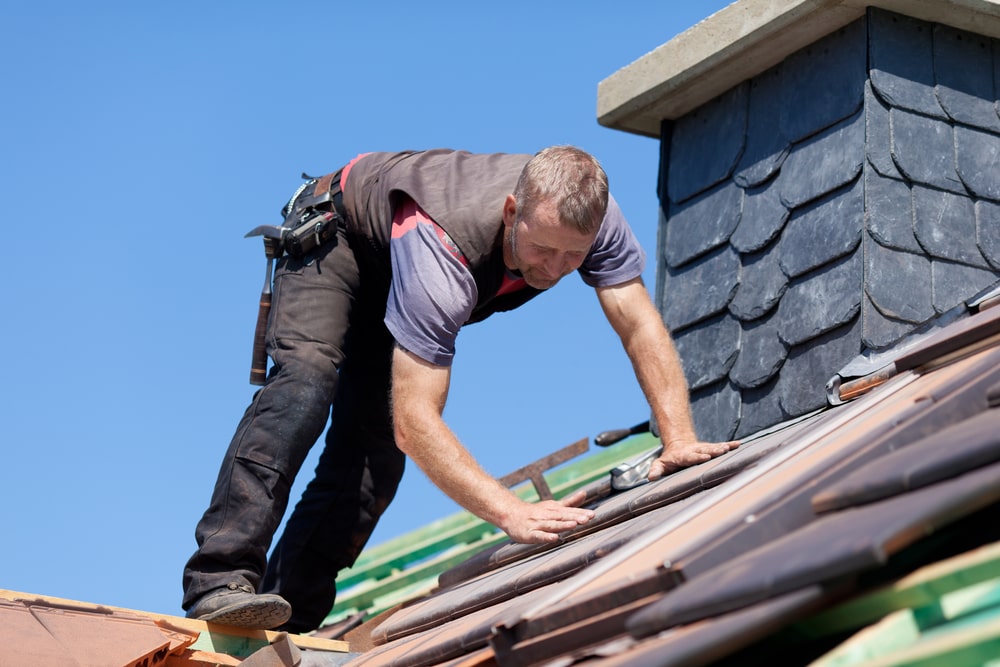Worker verifying roof repair